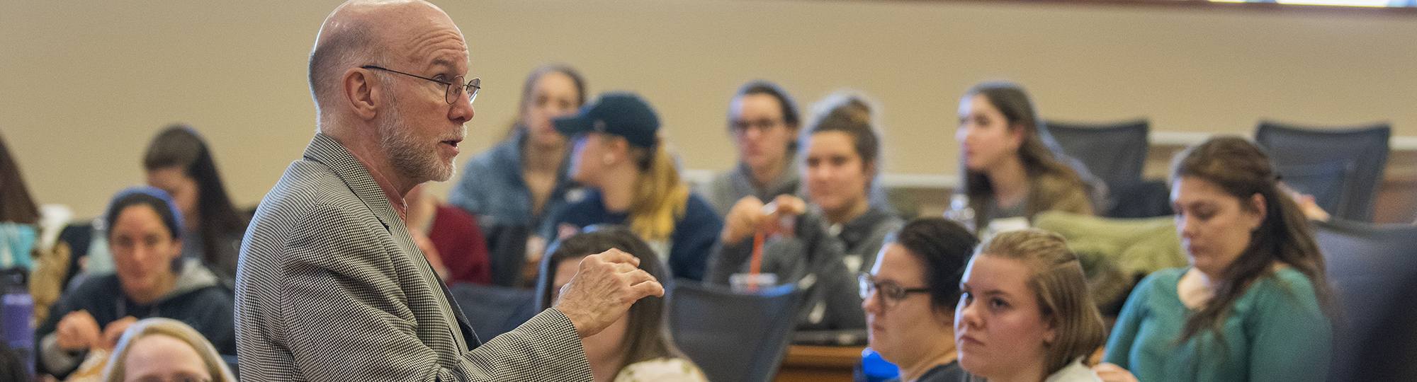 A professor gives a lecture to a room of students