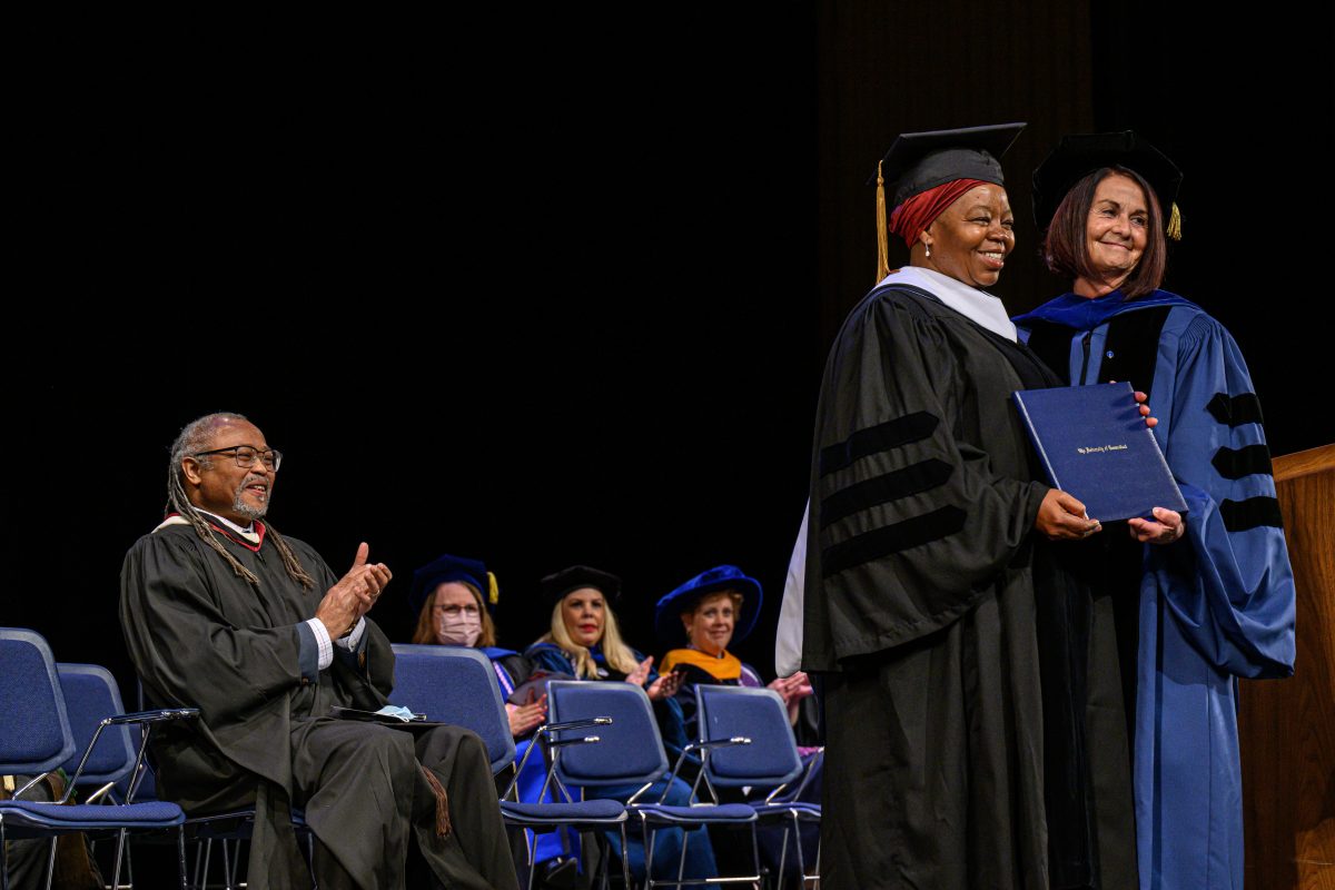 A woman receives an honorary diploma.