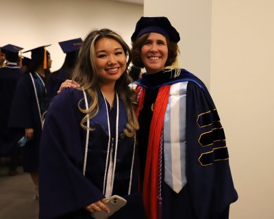 May gradation photo faculty and student pose. 