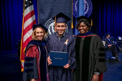 Graduation photo on stage receiving diploma